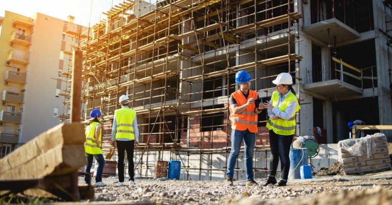 Four construction workers having meeting,stock photo